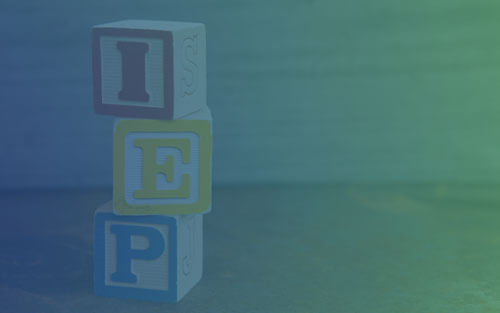 Blocks with letters stacked up spelling IEP.