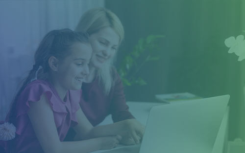 A child on a Zoom meeting with their parent and teacher.